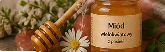 Słoik miodu z drewnianą łyżką do miodu
